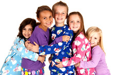 Happy Children In Winter Pajamas Hugging Each Other