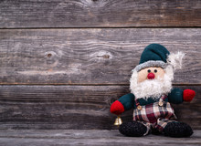 Santa Claus Toy Against Wooden Background - Christmas Concept