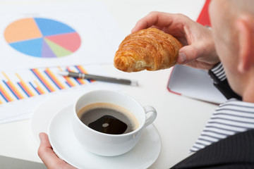 Canvas Print - Man in suit with coffee and roll