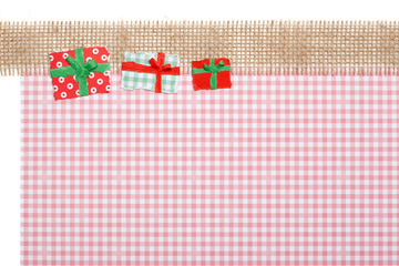 Wall Mural - Gifts on Jute and red checkered Background, Paper Tear, Christma