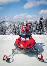 Couple Driving Snowmobile