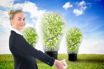 Poster - Composite image of businesswoman holding piggy bank
