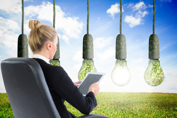 Poster - Composite image of businesswoman sitting on swivel chair with ta