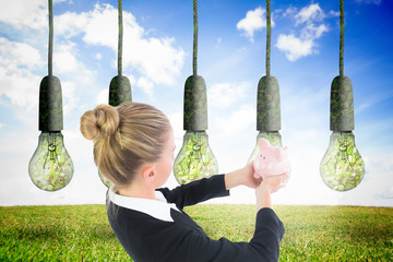 Poster - Composite image of businesswoman holding pink piggy bank