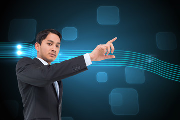 Poster - Composite image of serious asian businessman pointing