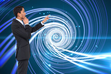 Poster - Composite image of thoughtful asian businessman pointing