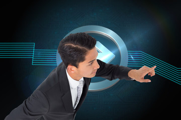 Poster - Composite image of unsmiling asian businessman pointing