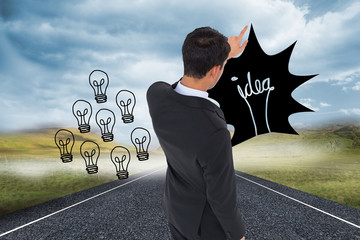Poster - Composite image of asian businessman pointing