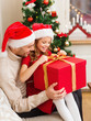 © Syda Productions - smiling father and daughter opening gift box