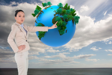 Aufkleber - Composite image of unsmiling asian businesswoman pointing