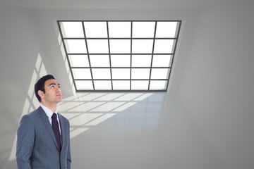 Poster - Composite image of unsmiling businessman standing