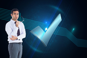 Poster - Composite image of unsmiling businessman holding glasses