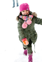 Happy Little Girl Running Away From Snowballs