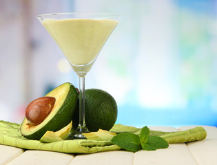 Wall Mural - Fresh avocado smoothie on bright background