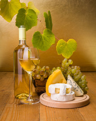 Wall Mural - White wine with grape and cheese snack