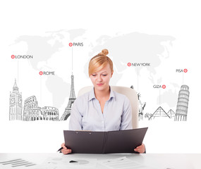 Beautiful businesswoman with world map and major landmarks of th