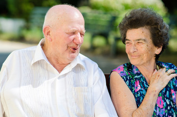 Senior man and woman smoking