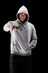 Poster - Young man with hood over his head with a gun symbolizing crime