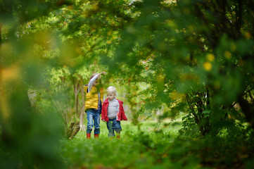 Wall Mural - Two sisters playing outside on an autumn day