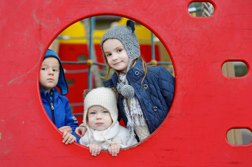 Wall Mural - Three kids on a playground