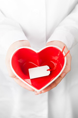 Fototapete - red heart shape in hands