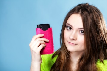 Wall Mural - Happy girl with mobile phone in pink cover