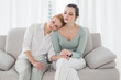 © lightwavemedia - Young woman consoling female friend on sofa