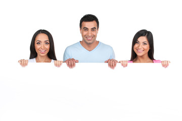 Group of Indian people standing behind blank poster.