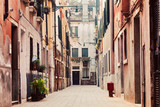 Fototapeta Uliczki - A narrow, old street in Venice, Italy