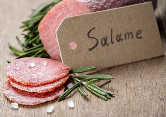 italian salami sausage slices with rosemary and sea salt