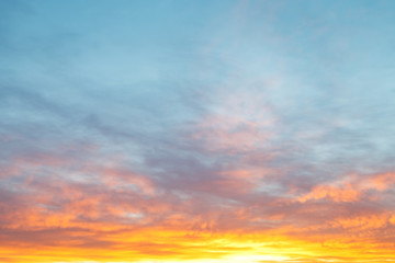 Wall Mural - blue morning sky over pink and yellow clouds
