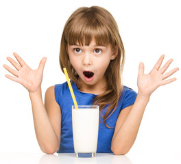 Cute little girl with a glass of milk