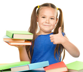 Wall Mural - Little girl is reading a book