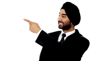 Indian businessman pointing away