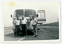 CIRCA 1960: Men Standing In Front Of The Bus, On The Road