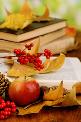 Fototapete - Books and autumn leaves on wooden table on natural background