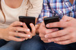 © Andrey Popov - Happy Couple Using Cellphone