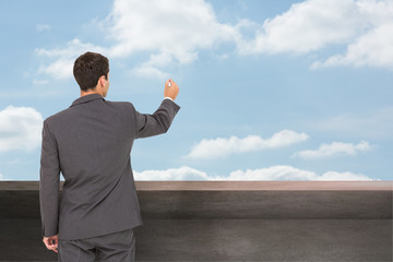 Poster - Composite image of businessman standing back to camera writing w