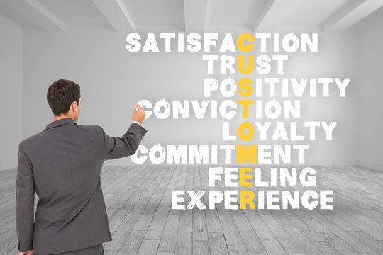 Composite image of businessman standing back to camera writing w