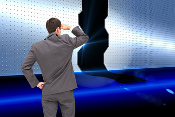 Poster - Composite image of businessman standing hand on hip