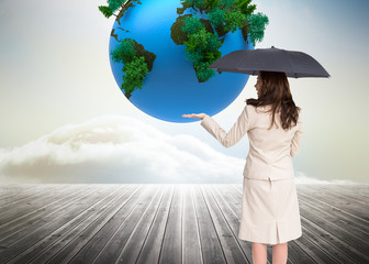 Poster - Composite image of elegant businesswoman holding black umbrella