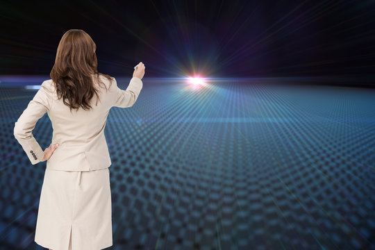 Composite image of businesswoman standing back to camera writing