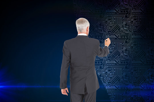 Composite image of rear view of businessman standing and writing