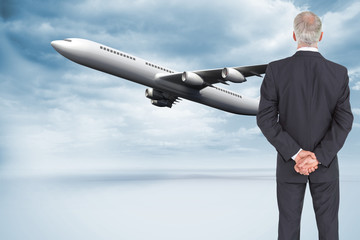 Poster - Composite image of rear view of serious businessman posing
