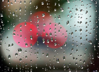 Wall Mural - rain drops on window with bokeh lights