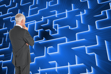 Poster - Composite image of thoughtful businessman standing back to camer