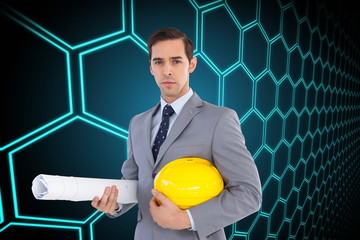 Wall Mural - Composite image of serious architect holding plans and hard hat