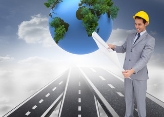 Poster - Composite image of smiling architect with hard hat looking at pl