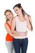 © lightwavemedia - Cheerful female embracing her friend from behind