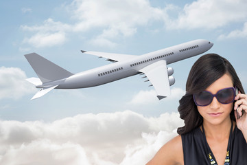 Poster - Composite image of serious elegant brunette wearing sunglasses o